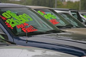 A display of cars for sale with prices in front