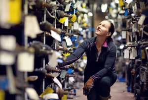 female mechanic working at storage